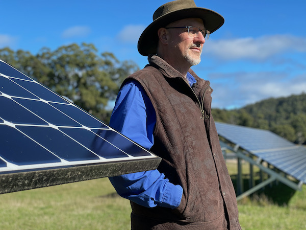 Simon Hackett with solar panel arrays at The Vale